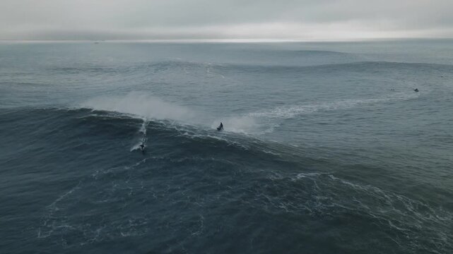 Jet ski surfer conquers massive waves at nazare beach in portugal
