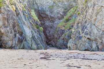 A rocky cove is visible, and the image is on a stock photo website. The cove has a small sand beach at the entrance in Polly Joke - Cornwall - UK