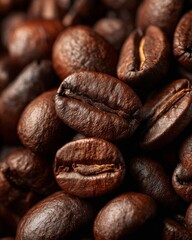 Naklejka premium A close-up of roasted coffee beans with rich dark tones and textured surfaces.