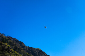 Tiny Helicopter Against an Immense Deep Blue Sky