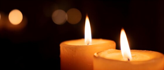 Warm candle flames glowing against a dark background. Ideal for themes of relaxation, spirituality, remembrance, meditation, and atmospheric design.