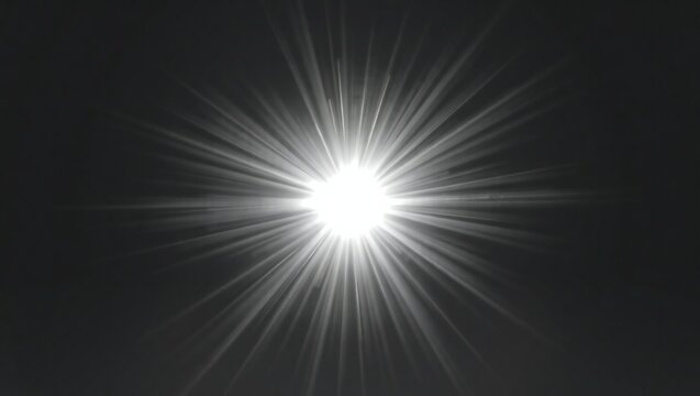 Bright starburst effect with radiant light rays on dark background