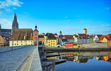 Stone Bridge and old colorful buildings in old town of Regensburg city, Germany.