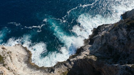 Fototapeta premium Dramatic Seascape of Powerful, Crashing Blue Ocean Waves Hitting the Shore or Rocky Cliff, Illustrating the Raw Energy and Force of Nature.