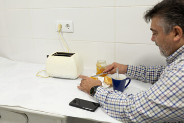 Man preparing breakfast with coffee and toast jam