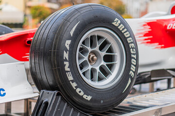 Naklejka premium White and red Toyota Formula 1 car TF-108 on a metal grid stand, parked in a garage or pit area Car has visible front and rear wings, tread pattern detail on one ti - Kyiv, Ukraine 10-10-2024