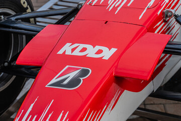 Naklejka premium Red and black Formula 1 Toyota TF-108 car with aerodynamic structure, parked in an urban setting, displaying KASPA and number 5 on the body Natural daylight - Kyiv, Ukraine 10-10-2024