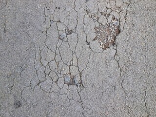 Cracked and damaged asphalt texture, highway damage. Emergency conditions on asphalt. For background or industrial use.