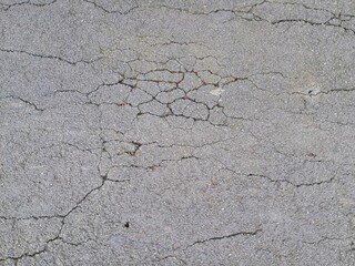 Cracked and damaged asphalt texture, highway damage. Emergency conditions on asphalt. For background or industrial use.