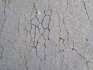 Cracked and damaged asphalt texture, highway damage. Emergency conditions on asphalt. For background or industrial use.