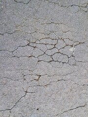 Cracked and damaged asphalt texture, highway damage. Emergency conditions on asphalt. For background or industrial use.