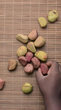 Overhead view of open kola nut on countertop, top view of fresh kolanut