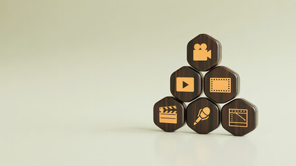 Hexagonal blocks with media and entertainment icons stacked in a pyramid formation