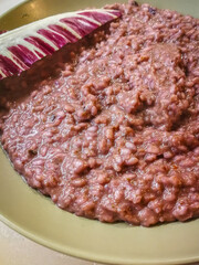 Background with a plate of risotto with red radicchio