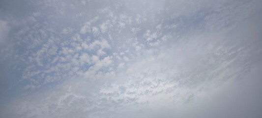 Fototapeta premium Scattered white clouds in a clear blue sky. Sky and cloud landscape. Sky background.