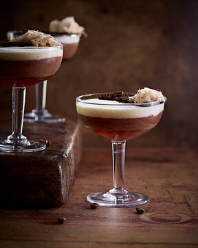 Elegant Chocolate Dessert Cocktails in Coupe Glasses on Rustic Table