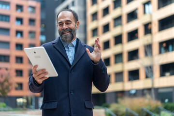 Mature man waving during virtual business video call