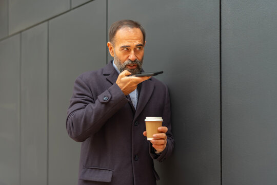 Mature man conversing on smartphone using voice message - Powered by Adobe