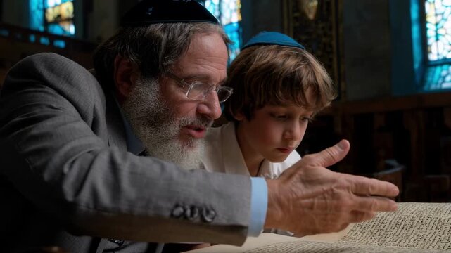 A Jewish man and a young boy reading from the Torah scroll in a synagogue. A rabbi teaching a student for his Bar Mitzvah. Religious education and tradition concept