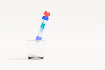 3D render of a stylized pH and temperature tester, featuring a heart icon, dipping into a glass of clear water against a white background, suggesting concepts of water quality, health, and purity.
