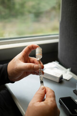 Drawing insulin into syringe from vial during diabetes medication preparation