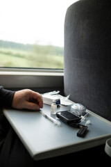 Insulin pump controller and infusion set components on train table during pump preparation