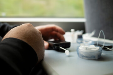 Insulin pump controller and infusion set components on train table during pump preparation