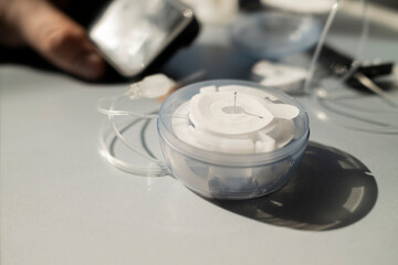 Close-up of diabetes infusion set cartridge and introducer needle in plastic container