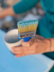Naklejka premium Artist Holding Brush with Blue Paint