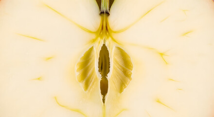 Fresh golden delicious apple cut in half showcasing its core, a healthy snack and fruit rich in nutrients, perfect for healthy recipes and diets