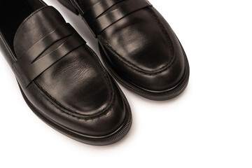 Black leather loafers isolated on white background.
