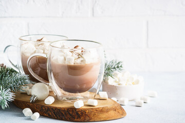 Christmas hot chocolate or cocoa with marshmallow on white with christmas decorations.