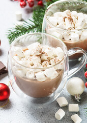Christmas hot chocolate or cocoa with marshmallow on white with christmas decorations.