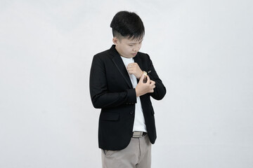 A focused young Asian professional adjusting a wristwatch on their sleeve, conveying a sense preparation, or time management against a clean white studio background