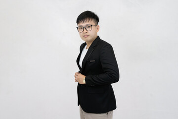 A cheerful and confident young Asian professional or student wearing a blazer and glasses, smiling against a clean white studio background