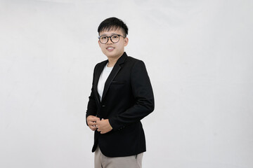A cheerful and confident young Asian professional or student wearing a blazer and glasses, smiling against a clean white studio background