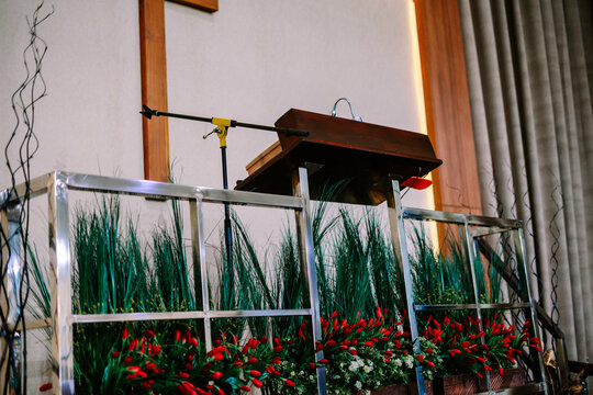 Ornate Podium and Floral Decorations in a Church Setting