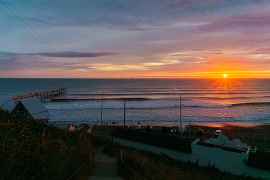 Sunset Over Saltburn Pier &mdash; Warm Glow, Pathway Descent, and Coastal Stillness in Saltburn-by-the-Sea