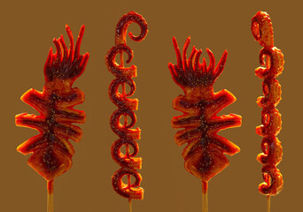 Grilled squid tentacle skewers coated in spicy, glossy mala sauce in a Chinese street-food style