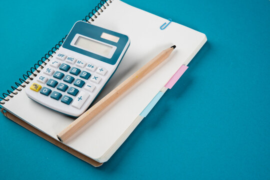 Calculator, notepad with bookmarks and stickers. The concept of diligent study of mathematics, physics and economics