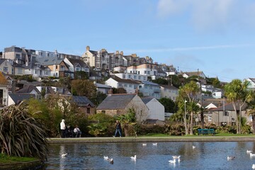 Cornwall coastal townscape with a pond and various white birds in Perranporth - Cornwall - UK