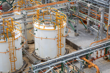 Chemical storage tanks equipped with various piping systems and surrounding fire hydrant safety systems ensure secure storage,