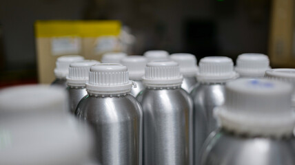 Chemical samples stored in aluminum bottles awaiting delivery for quality inspection in a chemical industrial plant,