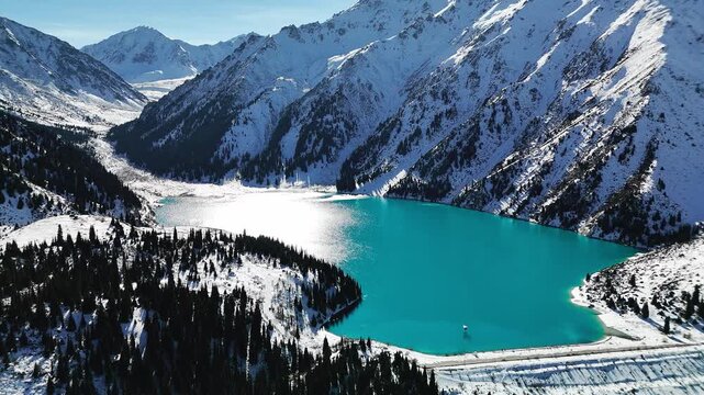Aerial view of mountain lake at winter with snow