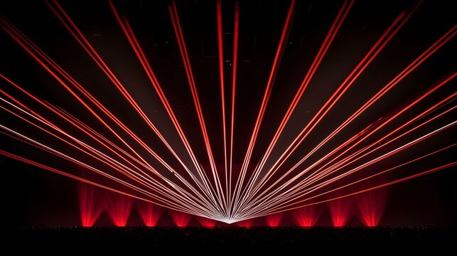 A concert scene bathed in red laser lights features an enthusiastic crowd gathered in the darkness, as vibrant beams of light pierce through the air in energetic patterns.