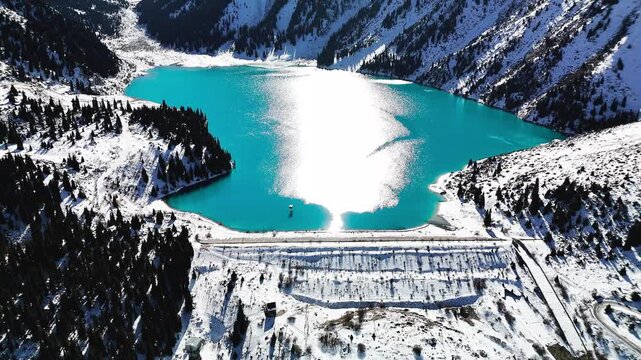 Aerial view of mountain lake at winter with snow