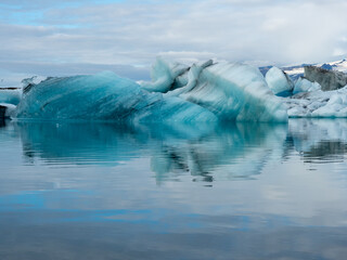Blue icebergs floating in Iceland's Jokulsarlon Glacier Lagoon in early morning