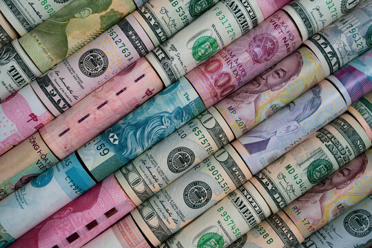 Close up top view of rolled international banknotes include dollar Yuan Yen Euro which showing global finance currency exchange and economic concepts for business investment financial market and money