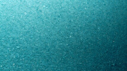 An oceanic textured background of turquoise grit. The fine shards glisten softly, an aqua cascade.