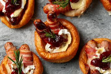 Stuffed Yorkshire Puddings with pig in blankets, camembert cheese and cranberry sauce